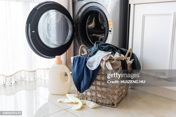 basket with laundry and washing machine - laundromat stock pictures, royalty-free photos & images