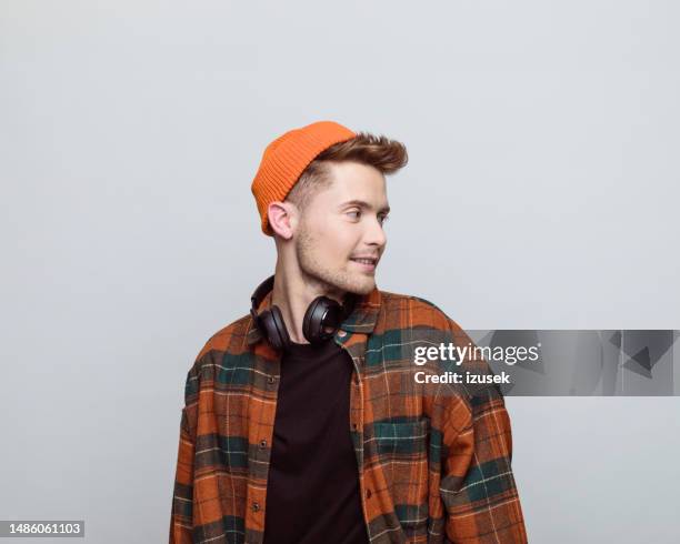 portrait of young man - orange hat stock pictures, royalty-free photos & images