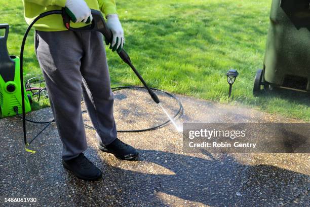 a portrait of a black man power washing a sidewalk - sidewalk sweeper imagens e fotografias de stock