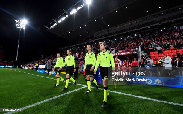 Referees lead the teams out during the round 26 A-League Men's match between Adelaide United and Central Coast Mariners at Coopers Stadium, on April...