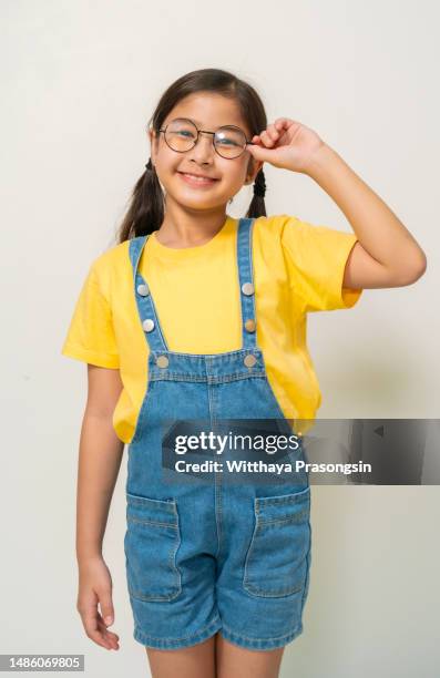 excited preschool small adorable girl in eyeglasses, - truehearts stock pictures, royalty-free photos & images
