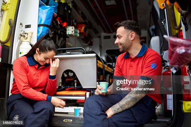 lighthearted ambulance staff taking a break - paramedic stock pictures, royalty-free photos & images
