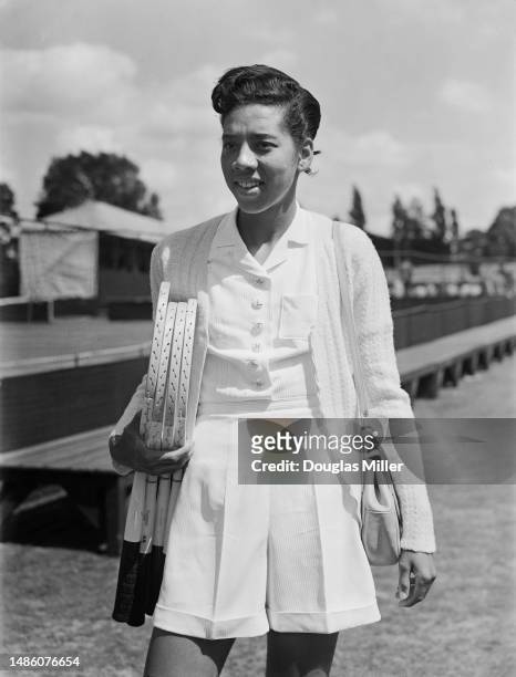 American tennis player Althea Gibson posing at the Kent Championships tennis tournament in Beckenham, Kent, on June 11th, 1951. The buttons on her...