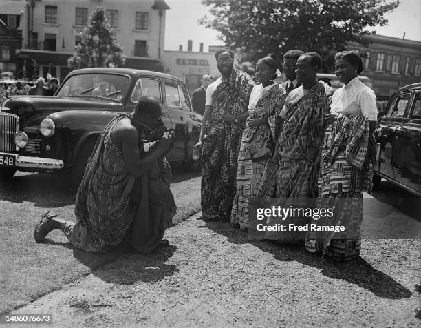 Photographer takes pictures of guests arriving for the wedding of Lady Peggy Cripps and Joseph Appiah at St John's Wood Church in London in June...