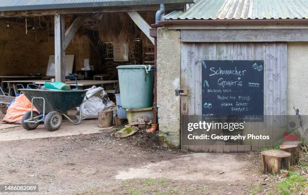 Growers producing vegetables and future farmers, Schumacher College, Dartington Hall estate, south Devon, England, UK.