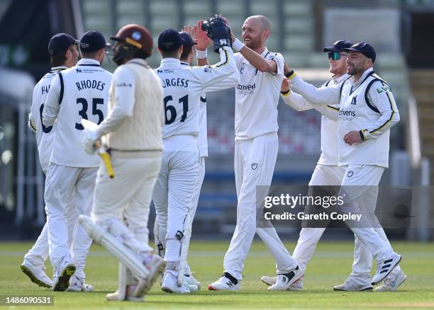 Oliver Hannon-Dalby of Warwickshire celebrates with teammates after dismissing Ryan Patel of Surrey during the LV= Insurance County Championship...