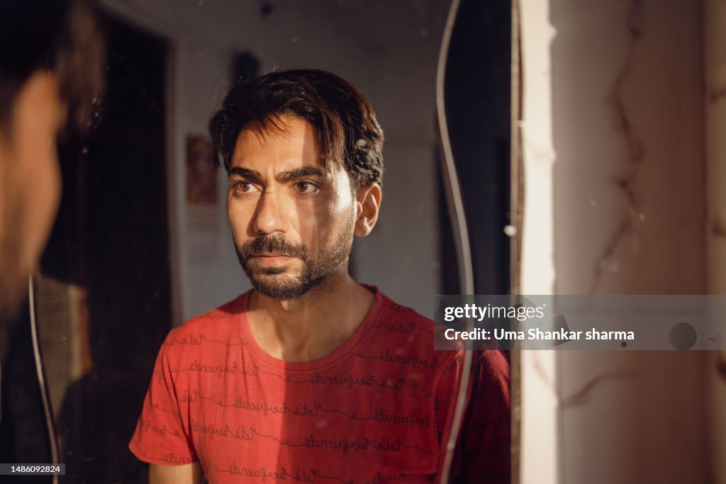 Mental health, Man gazing into mirror.