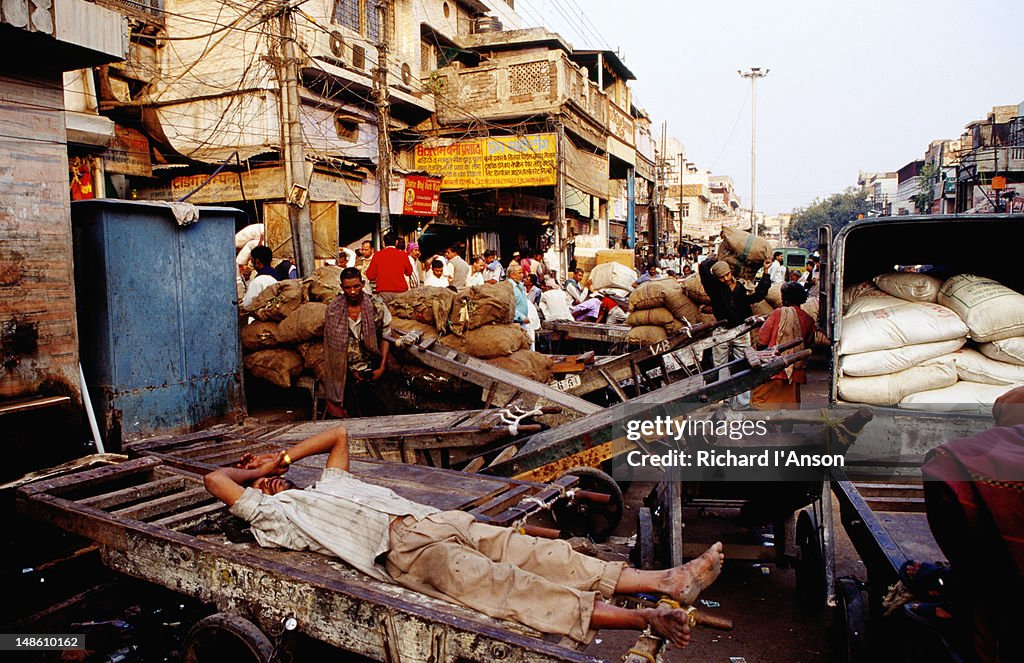 Porter resting on cart on Chandni Chowk, Old Delhi.