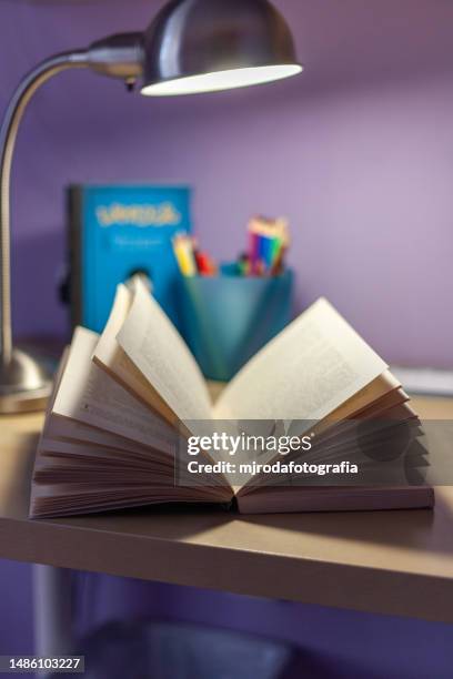 open and illuminated book on a youth desk - st georges day stock pictures, royalty-free photos & images