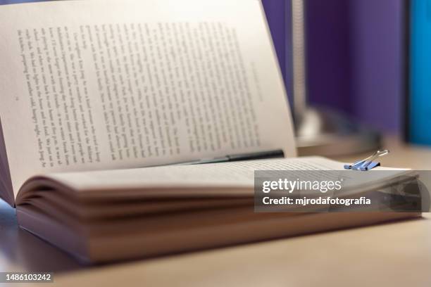 open and illuminated book on a youth desk - st georges day stock pictures, royalty-free photos & images