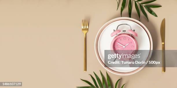 composition with cutlery,measuring tape and alarm clock on color background diet concept,copy space,romania - fasting stock pictures, royalty-free photos & images