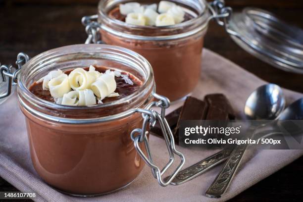 close-up of food in jar on table,romania - chocolade mousse stockfoto's en -beelden