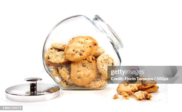 homemade cookies in glass jar on white,romania - cookie jar stock-fotos und bilder