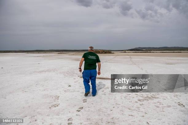 Eduardo, one of the guardians of the Laguna de Fuente de Piedra walks through the dry and covered in salt part of the lagoon on April 28, 2023 in...