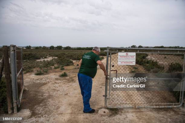 Eduardo, a guardian of the Fuente de Piedra Lagoon, opens the gate to access the lane that surrounds the lagoon on April 28, 2023 in Fuente de...