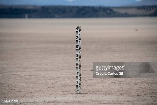 Level meter stuck into the ground of the dry Fuente de Piedra lagoon on April 28, 2023 in Fuente de Piedra, Spain. Due to the lack of rainfall and...
