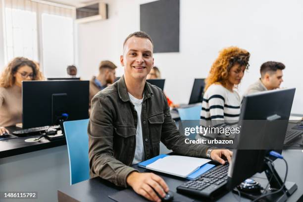 young man in a programing class - male student computer stock pictures, royalty-free photos & images
