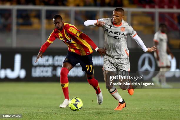 Assan Ceesay of Lecce competes for the ball with Rodrigo Becao of Udinese during the Serie A match between US Lecce and Udinese Calcio at Stadio Via...