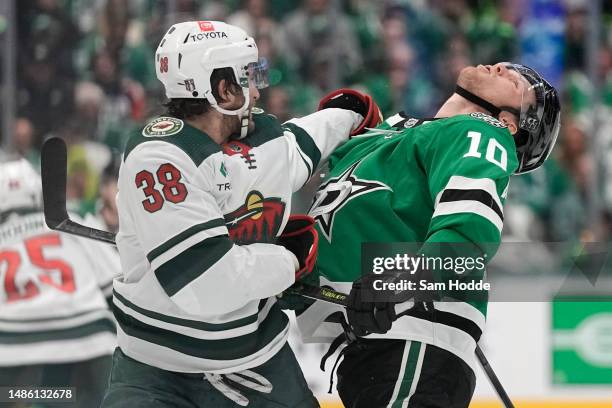 Ryan Hartman of the Minnesota Wild punches Ty Dellandrea of the Dallas Stars during the third period in Game Five of the First Round of the 2023...