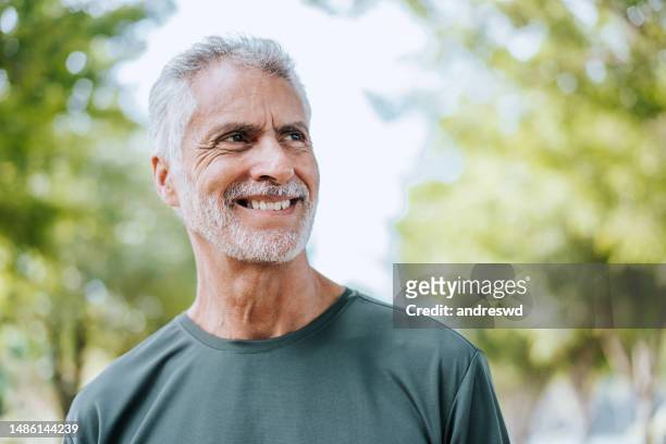 portrait of a senior man on a workout in the public park - testimonial portrait smile stock pictures, royalty-free photos & images