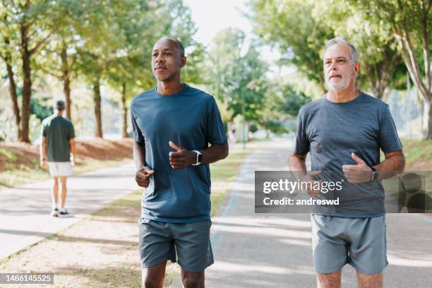 deux amis qui courent dans le parc public - black and white photo out door sport photos et images de collection