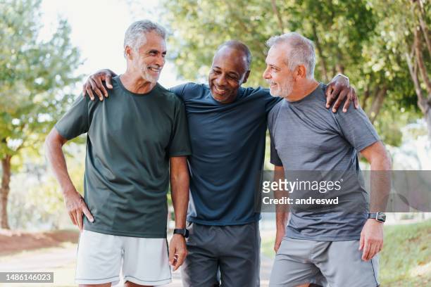 three friends having fun in the public park - old guy stock pictures, royalty-free photos & images