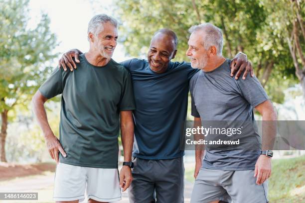 three friends having fun in the public park - men group stock pictures, royalty-free photos & images