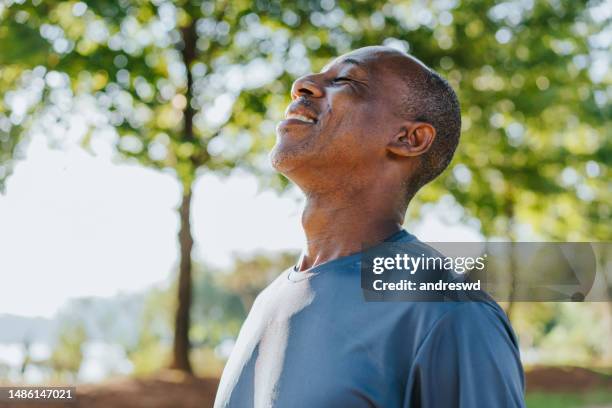 portrait of a mature man breathing fresh air - breathing exercise 個照片及圖片檔