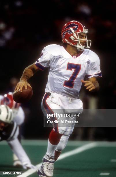 Quarterback Doug Flutie of the Buffalo Bills scrambles with the ball in the game between the Buffalo Bills vs the New York Jets at The Meadowlands on...