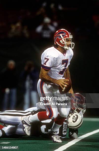 Quarterback Doug Flutie of the Buffalo Bills scrambles with the ball in the game between the Buffalo Bills vs the New York Jets at The Meadowlands on...