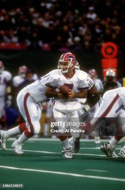 Quarterback Doug Flutie of the Buffalo Bills scrambles with the ball in the game between the Buffalo Bills vs the New York Jets at The Meadowlands on...