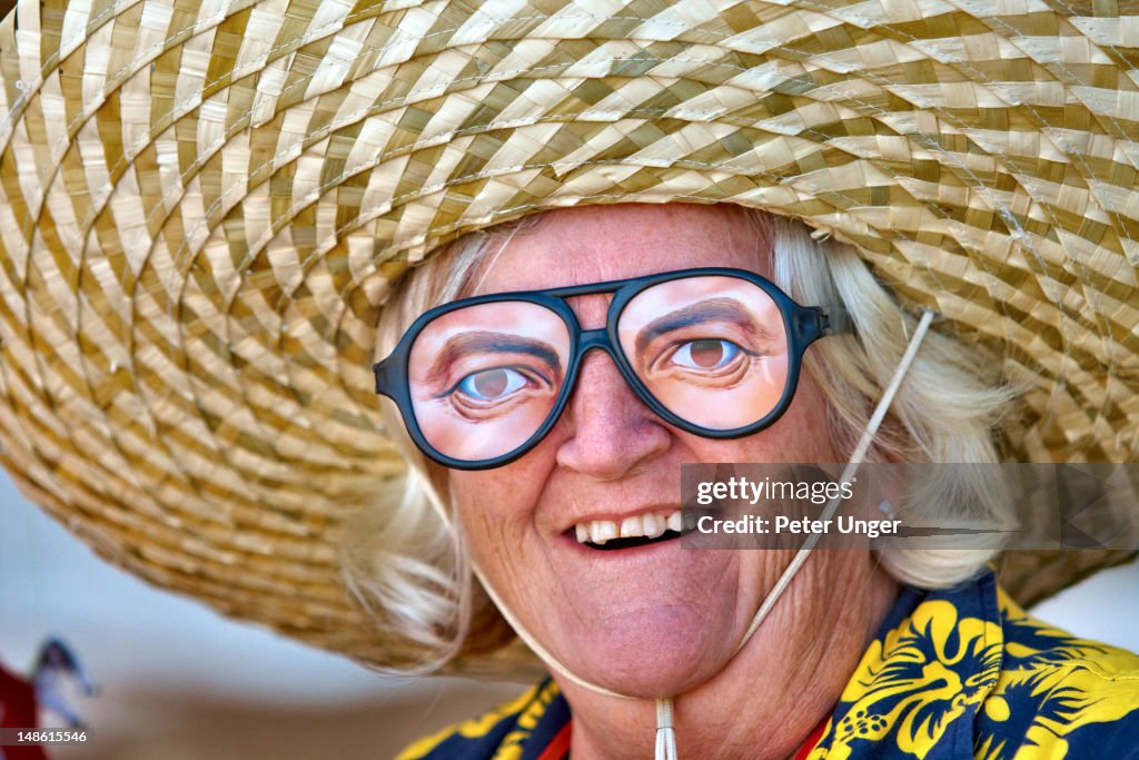 Lady dressed up and wearing funny eyewear.