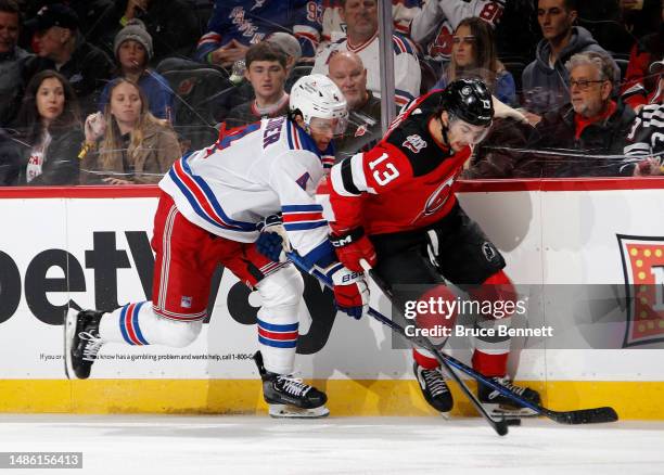 Braden Schneider of the New York Rangers checks Nico Hischier of the New Jersey Devils in Game Five of the First Round of the 2023 Stanley Cup...