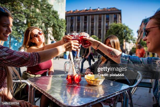 tourist women in madrid, drinking vermouth in a bar - aperitief stockfoto's en -beelden