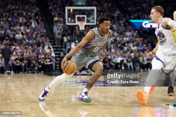 Malik Monk of the Sacramento Kings dribbles the ball against the Golden State Warriors during Game Five of the Western Conference First Round...