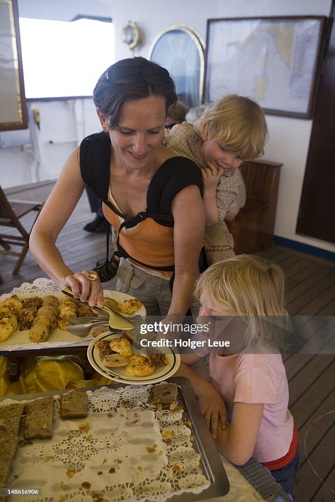 Mother and children enjoy afternoon snack buffet aboard sailing cruiseship Star Flyer (Star Clippers Cruises)during Mediterranean Sea voyage.