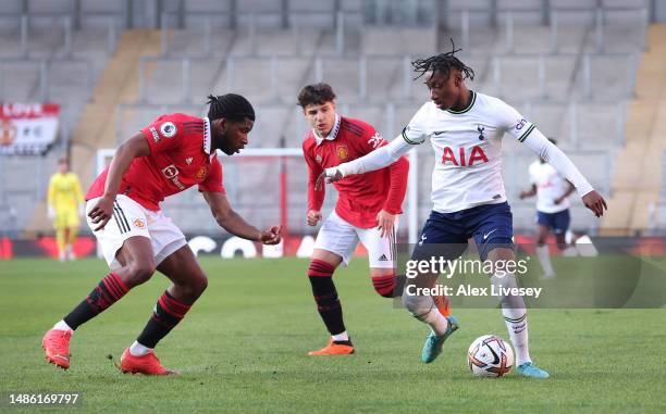 Romaine Mundle of Tottenham Hotspur U21 takes on Will Kambwala of Manchester United U21 during the Premier League 2 match between Manchester United...