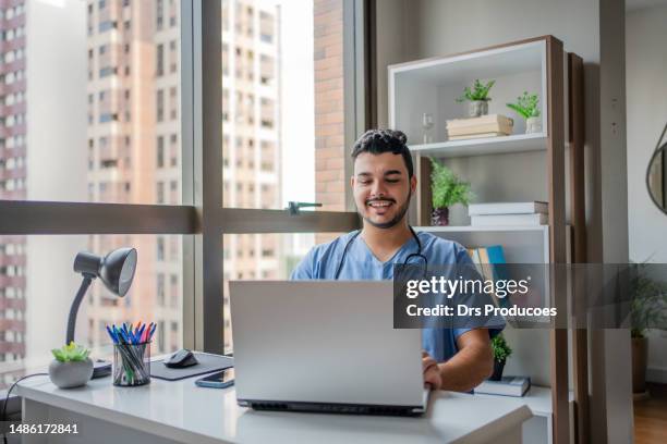 male nurse on telemedicine in his office - doctor laptop stock pictures, royalty-free photos & images