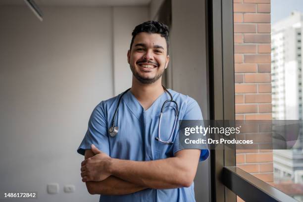 portrait of male nurse in his office - doctor portrait stock pictures, royalty-free photos & images