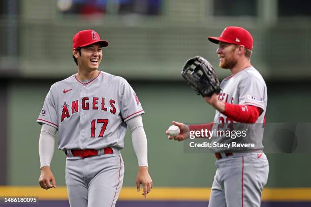 Shohei Ohtani of the Los Angeles Angels speaks with Brandon Drury prior to a game against the Milwaukee Brewers at American Family Field on April 28,...