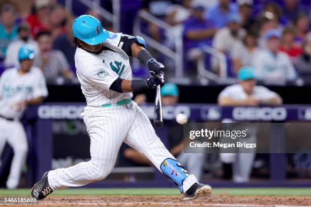 Jean Segura of the Miami Marlins hits a RBI single against the Chicago Cubs during the seventh inning of the game at loanDepot park on April 28, 2023...