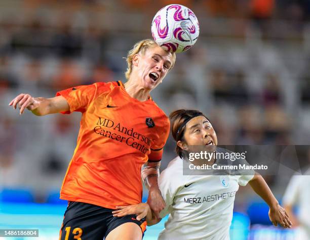 Sophie Schmidt of Houston Dash heads a ball over Abby Erceg of North Carolina Courage during the first half at Shell Energy Stadium on April 28, 2023...