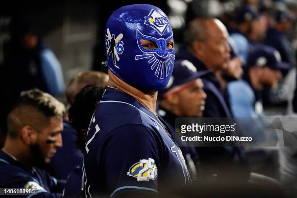 Harold Ramirez of the Tampa Bay Rays wears a mask in the dugout following the home run by teammate Isaac Paredes against the Chicago White Sox at...