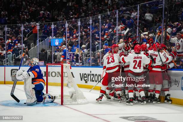 The Carolina Hurricanes celebrate after defeating the New York Islanders in overtime in Game Six of the First Round of the 2023 Stanley Cup Playoffs...