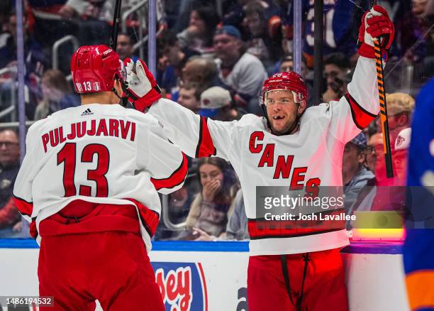 Paul Stastny of the Carolina Hurricanes celebrates with teammates after scoring the game-winning goal in overtime to defeat the New York Islanders in...