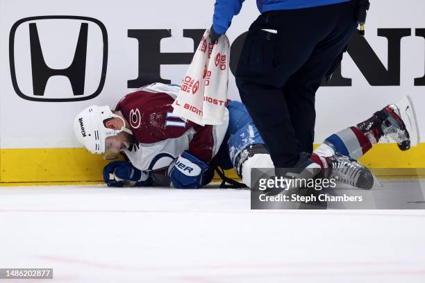 Andrew Cogliano of the Colorado Avalanche is tended to by medical staff against the Seattle Kraken during the second period in Game Six of the First...