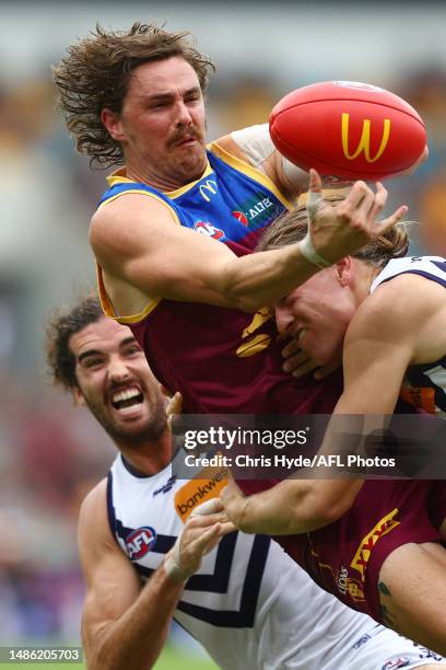 Joe Daniher of the Lions is tackled by Hayden Young of the Dockers during the round seven AFL match between Brisbane Lions and Fremantle Dockers at...