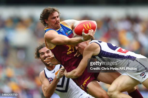 Joe Daniher of the Lions is tackled by Hayden Young of the Dockers during the round seven AFL match between Brisbane Lions and Fremantle Dockers at...