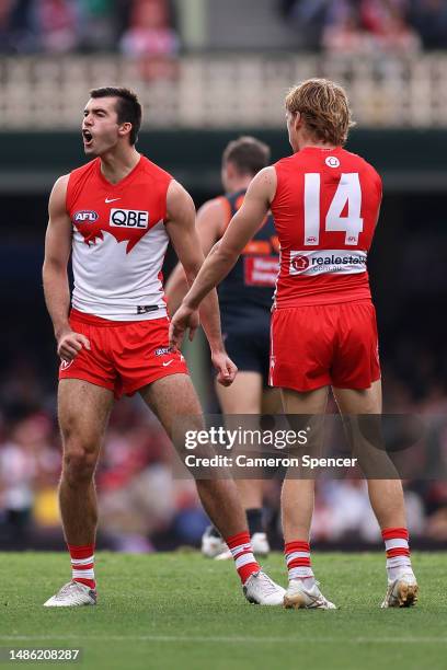 Logan McDonald of the Swans celebrates kicking a goal with Callum Mills of the Swans during the round seven AFL match between Sydney Swans and...