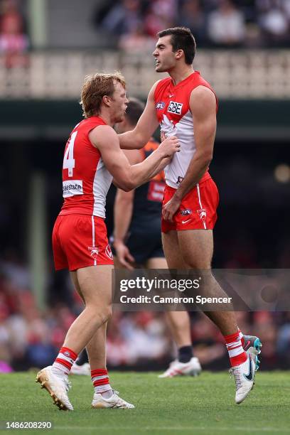 Logan McDonald of the Swans celebrates kicking a goal with Callum Mills of the Swans during the round seven AFL match between Sydney Swans and...